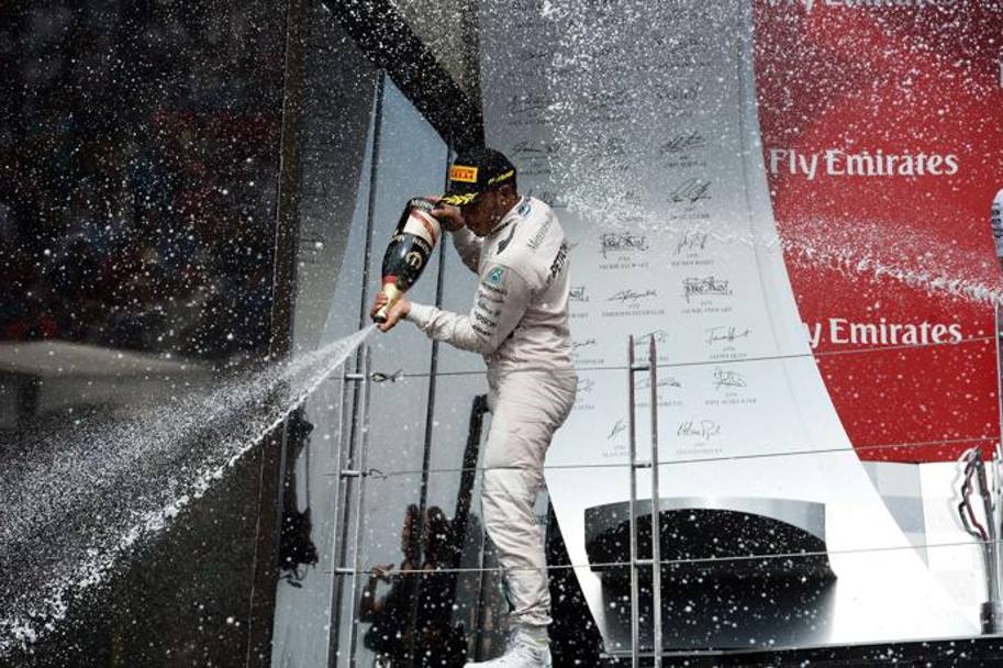 Hamilton festeggia sul podio. Afp